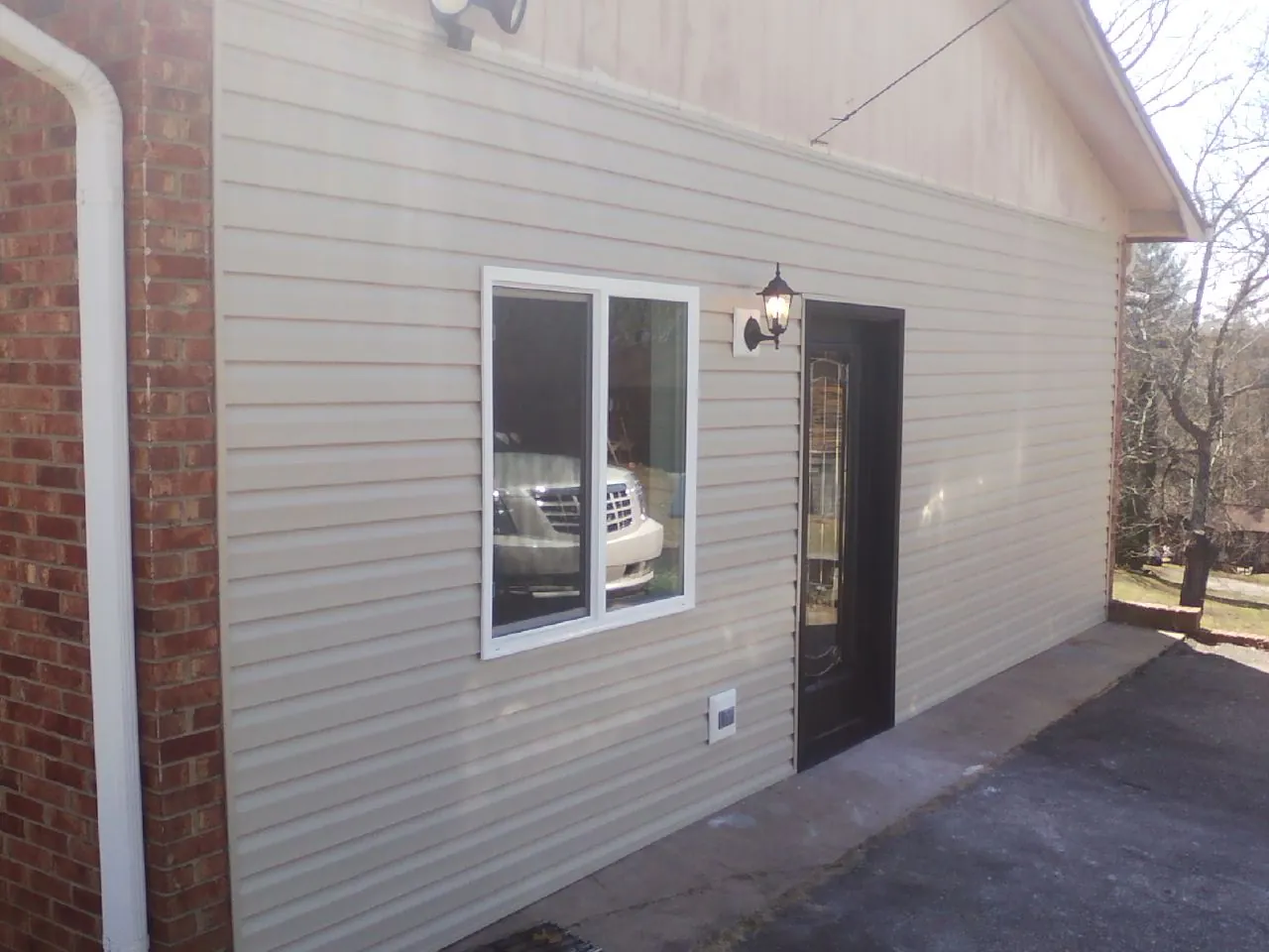 New vinyl siding and entry door on a room addition in Waynesboro