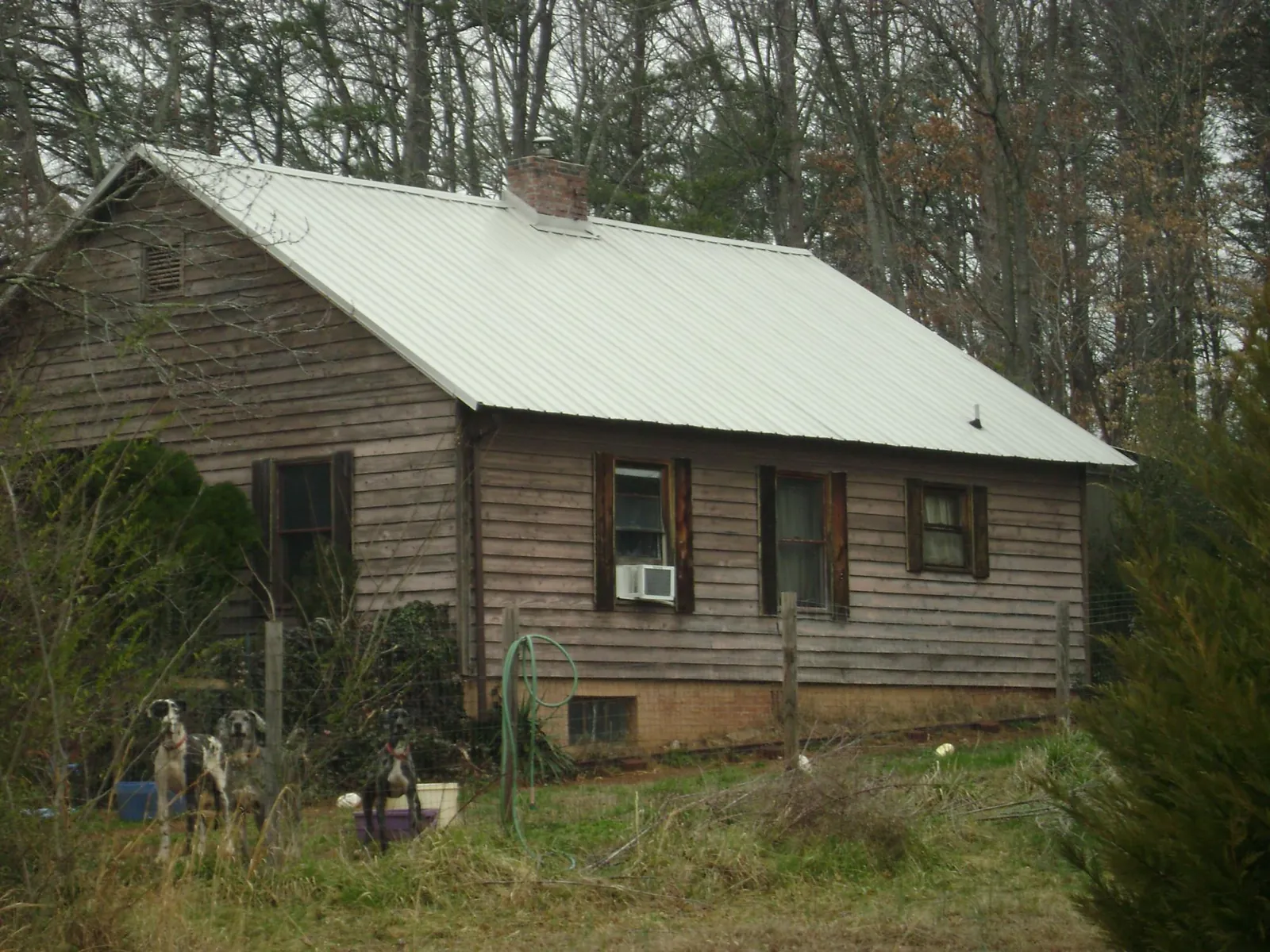White metal roof on an old wood sided farmhouse, from a Asphalt Shingle Roof Repair job in Waynesboro